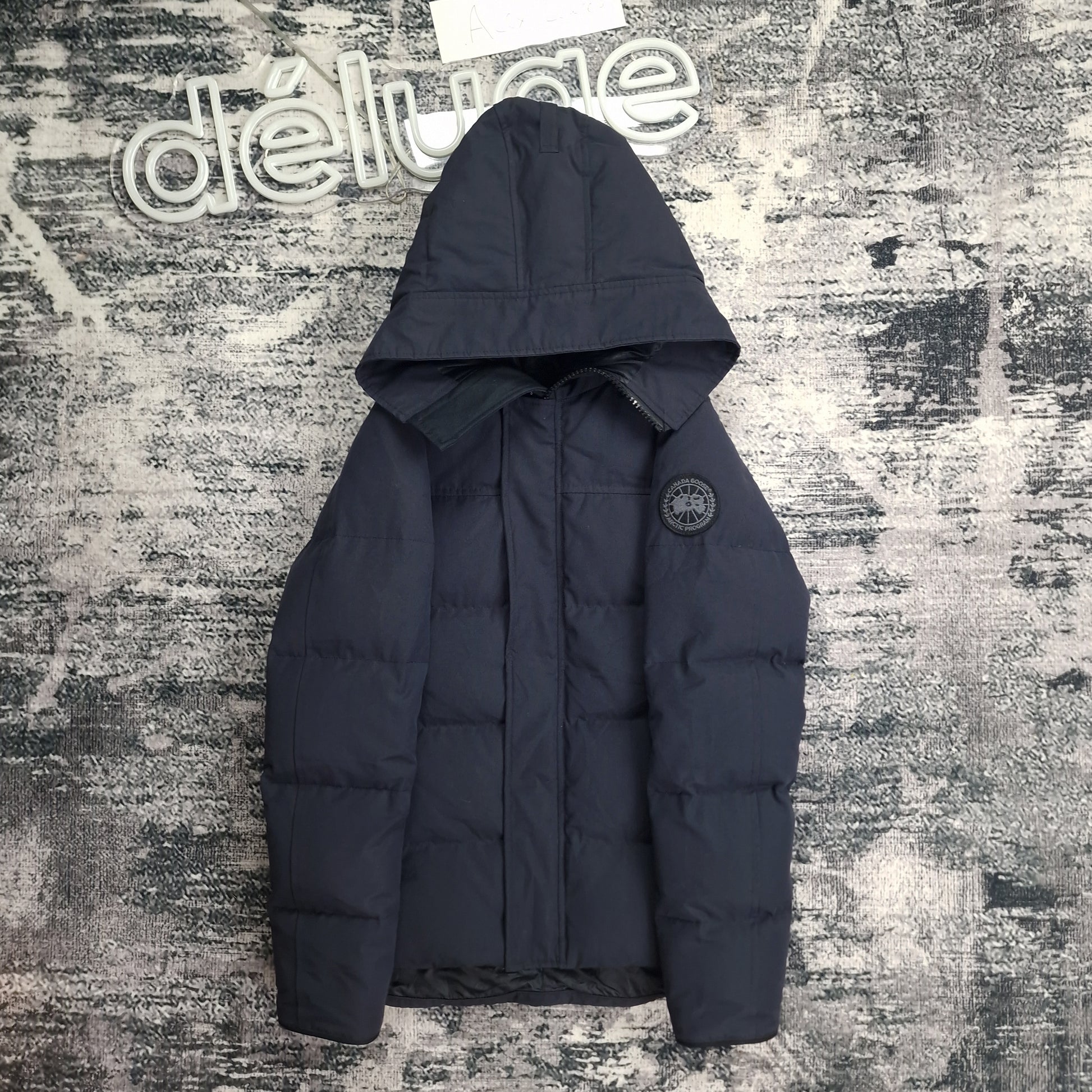 Canada Goose Macmillan Black Label Navy XS front view on neutral background at DelugeStore. Clean studio shot of men's luxury parka. Premium down-filled winter jacket with black badge. Shop online.