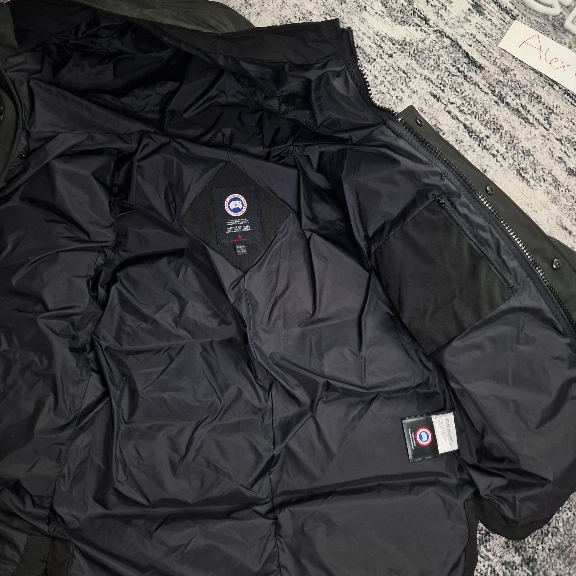 Interior view of Canada Goose Macmillan Parka 3804MA men's large showing black lining and authentic interior tags