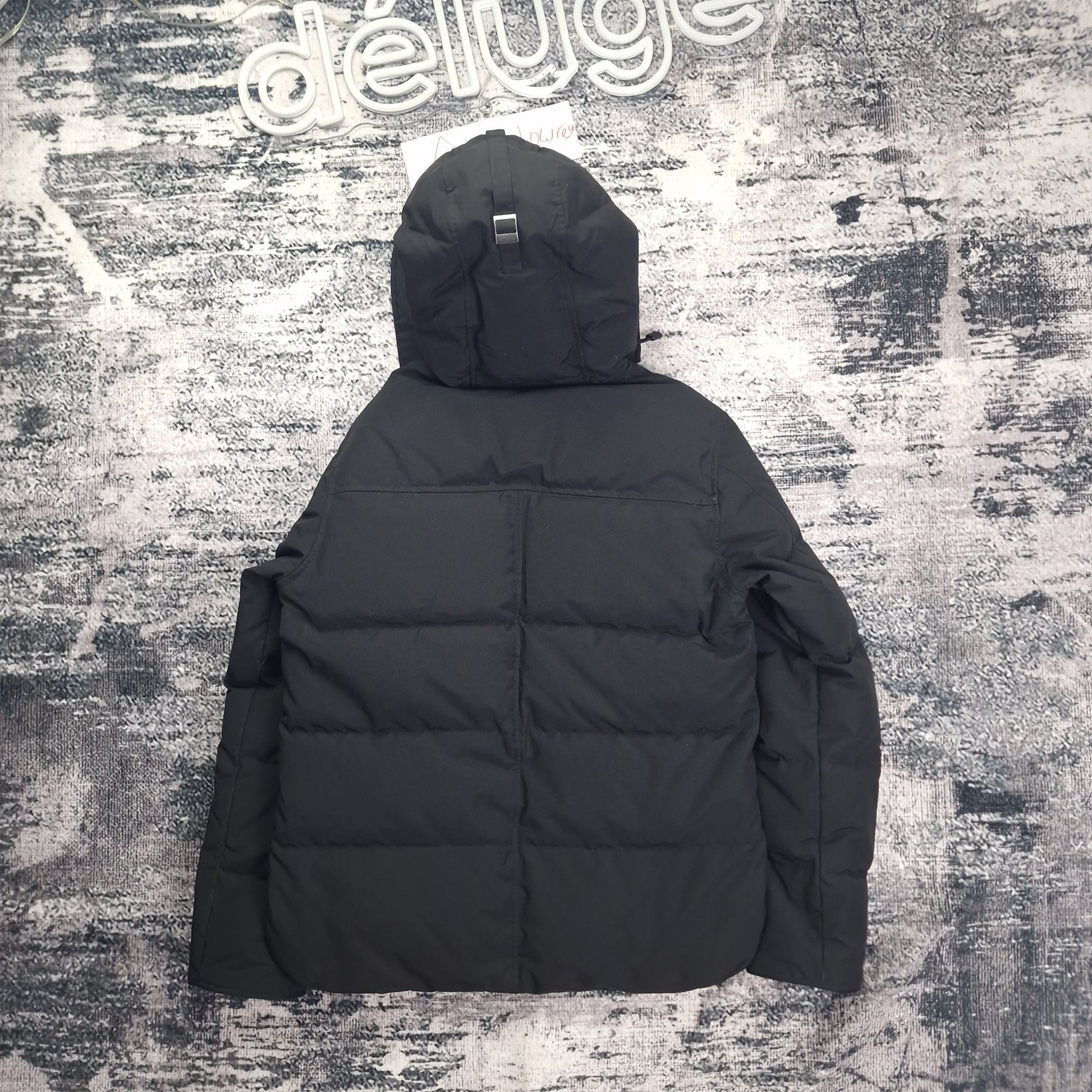 Back flat lay of Canada Goose Macmillan Parka men's large in black displaying quilted channels and hood detail