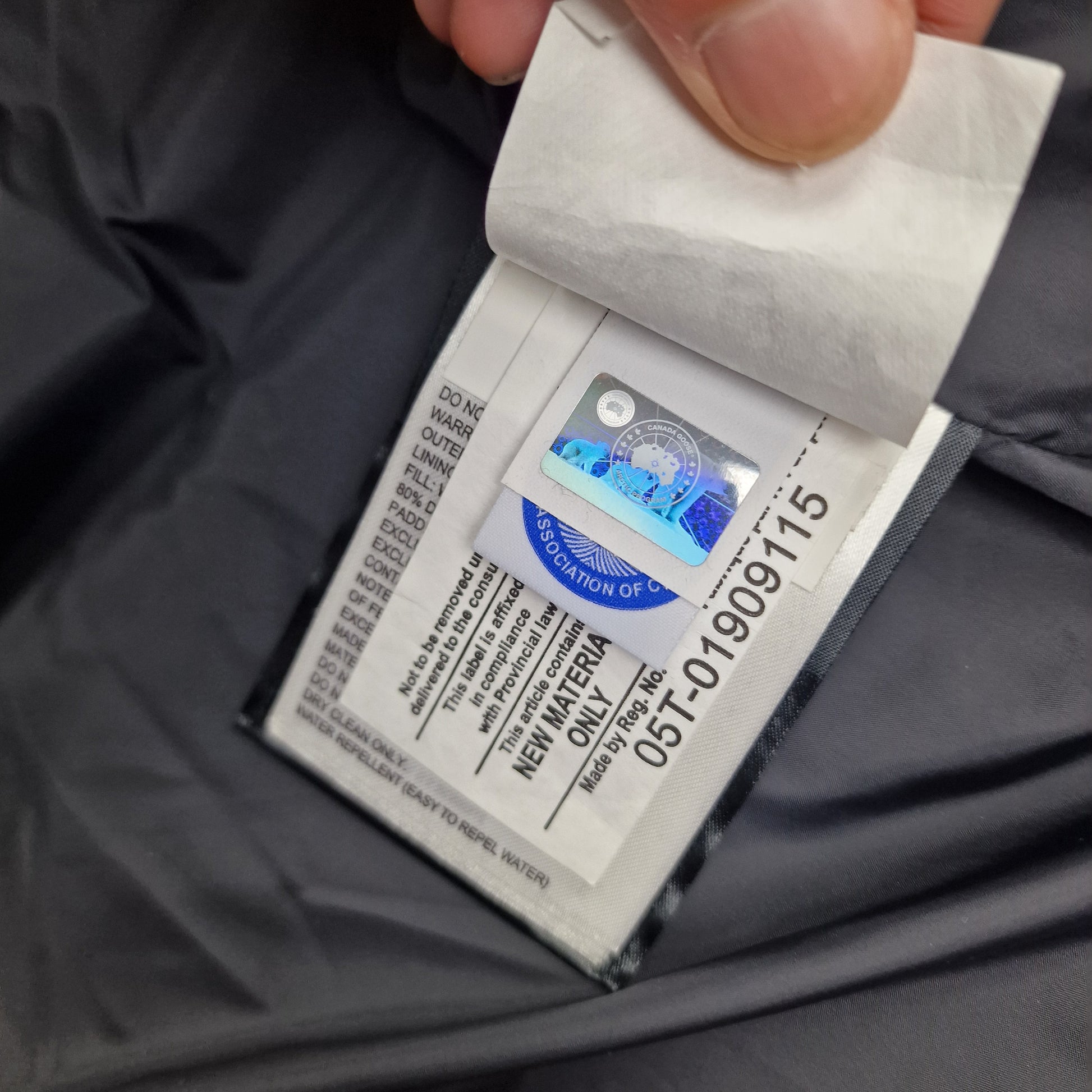 Authentic Canada Goose hologram security tag with serial number showing genuine Macmillan Parka verification and quality certification