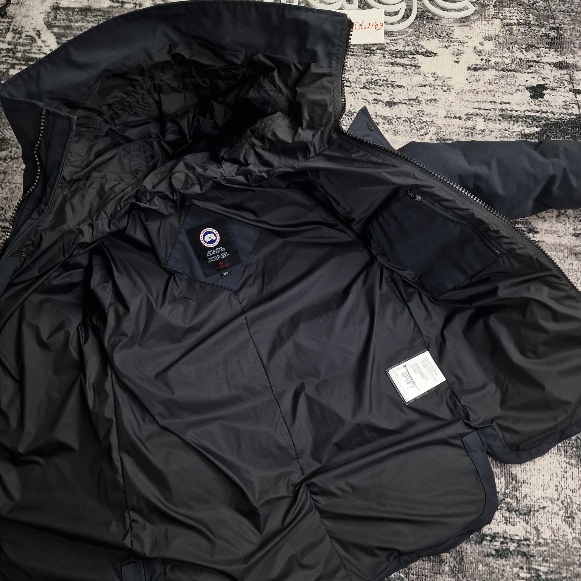 Interior view of Canada Goose Macmillan Parka 3804M men's XS showing black lining and authentic interior tags