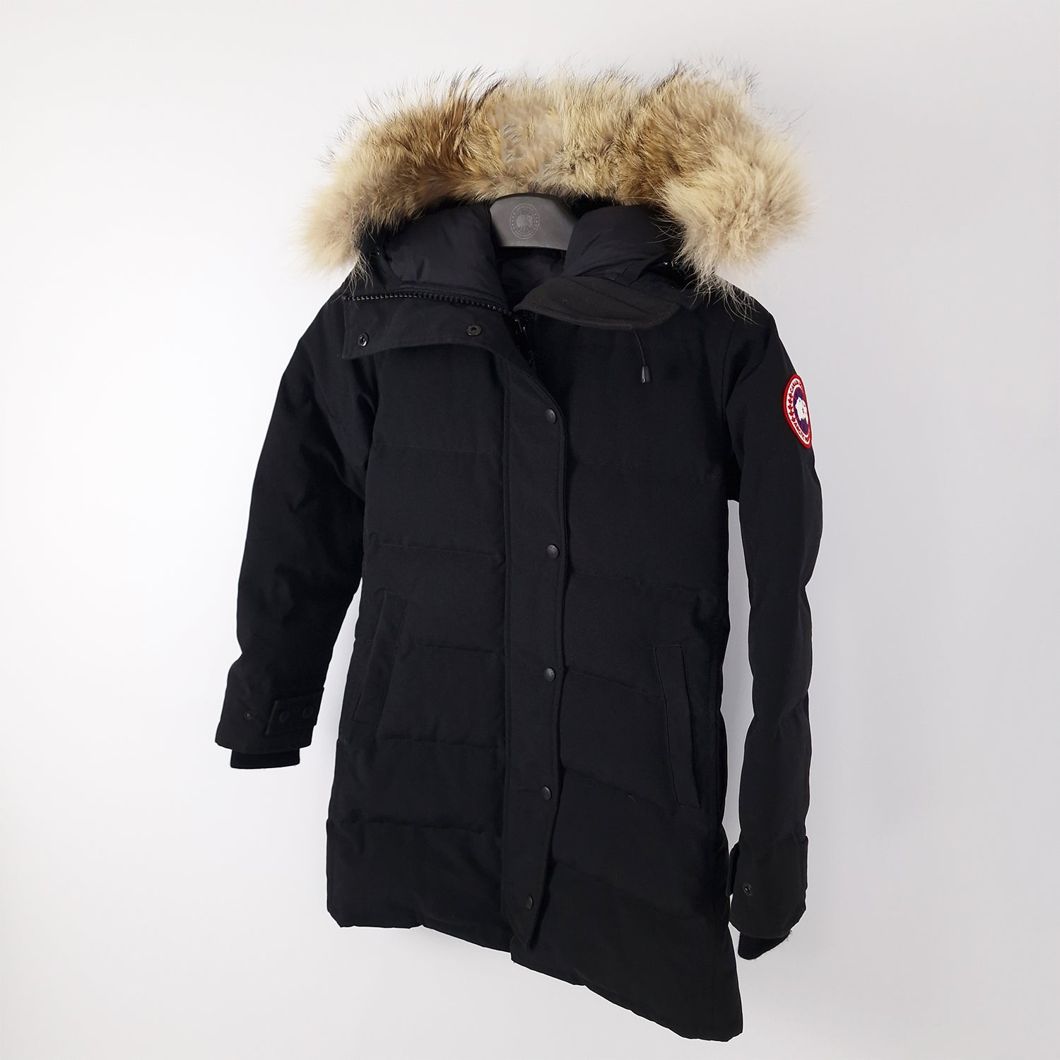 Angled view of black Canada Goose Shelburne Parka women's small displaying coyote fur hood and tailored knee-length fit
