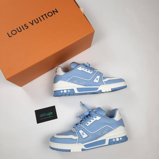 Side profile of Louis Vuitton Trainer luxury blue sneakers showing LV monogram details, premium leather construction, men's size 8