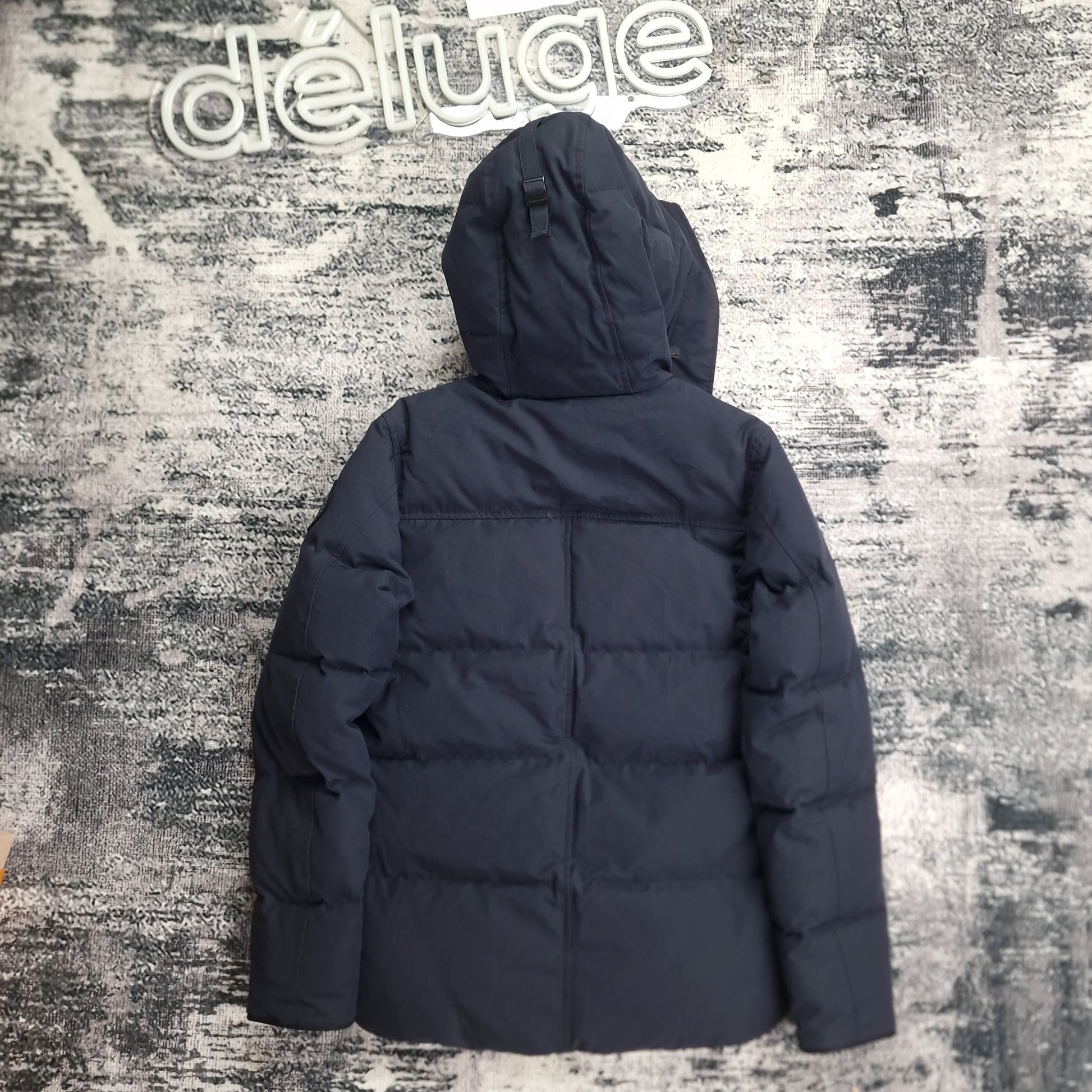 Canada Goose Macmillan Black Label Navy XS back view on smooth background at DelugeStore. Clean rear shot showing sleek silhouette and Arctic disc logo. Men's luxury down parka. Authentic outerwear.