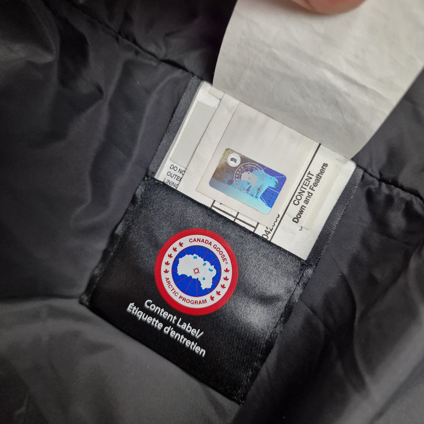 Canada Goose Authenticity Hologram Tag Close-Up on Wyndham Parka Heritage